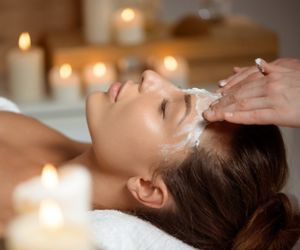 Young beautiful girl in mask for face relaxing in spa salon.